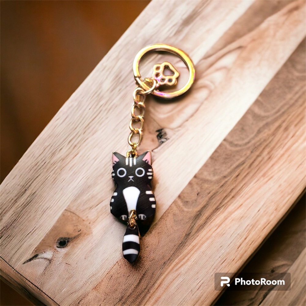 Cat charm.  Black cat with frown & white belly